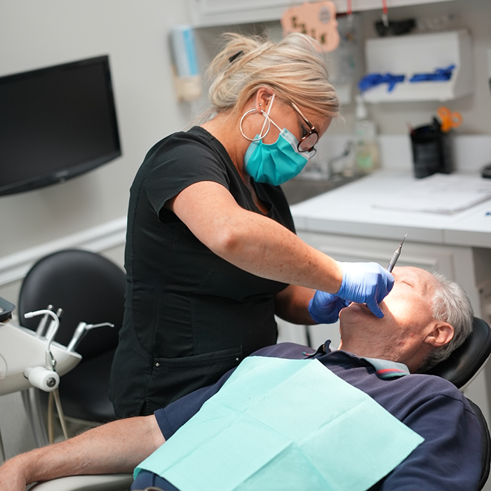 Dental hygienist giving a patient a teeth cleaning