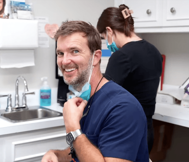 Dr. Barganier pulling down his mask to smile