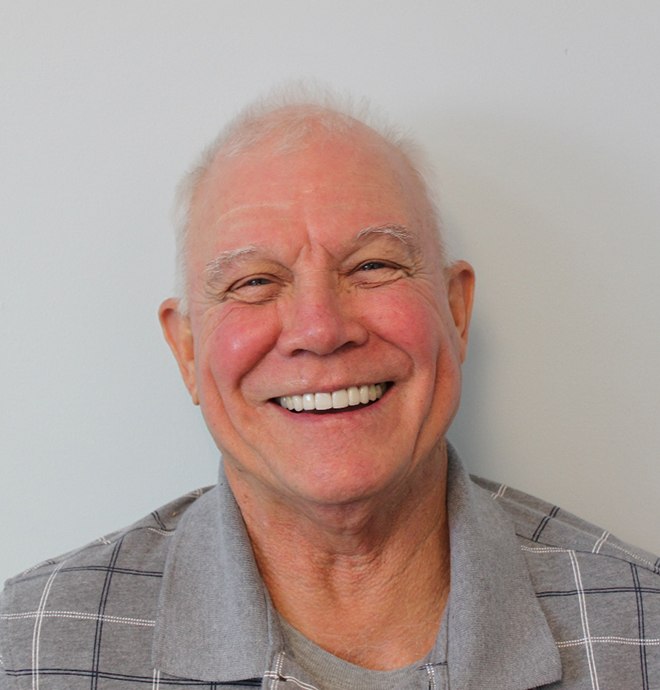 Happy, smiling patient after receiving treatment at Carolina Complete Dental