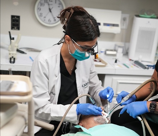 Dr. Zuffi chairside with patient