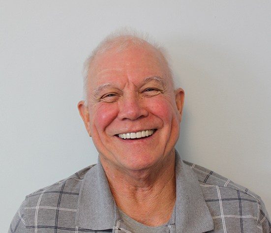 Portrait of senior man with beautiful teeth after dental treatment