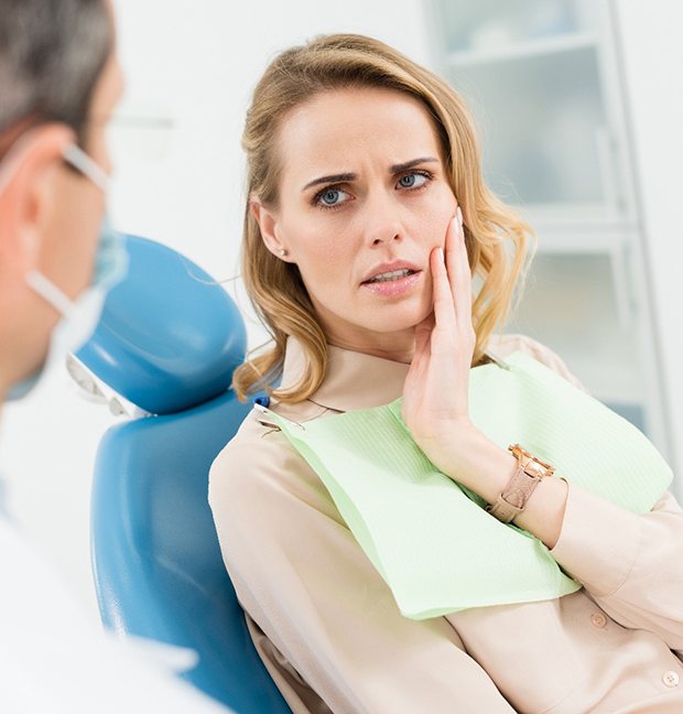 Patient with toothache talking to her dentist