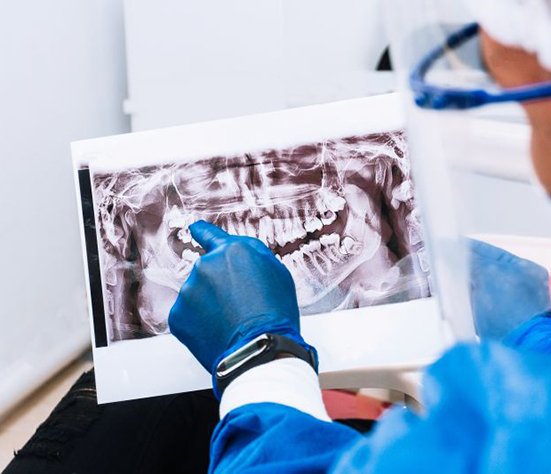 Dentist and patient looking at X-ray