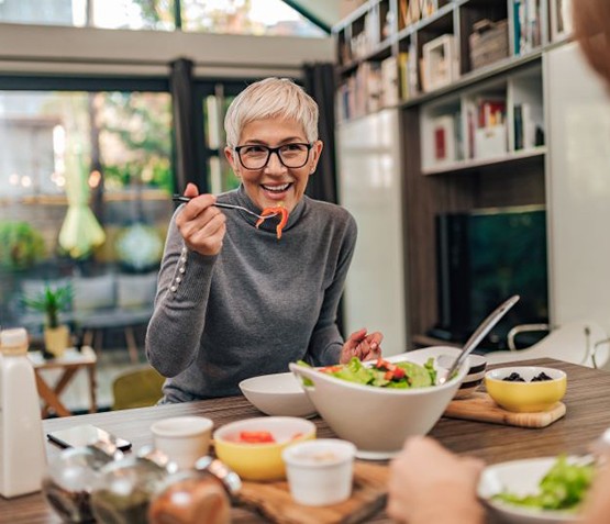 Senior woman enjoying a meal with a friend