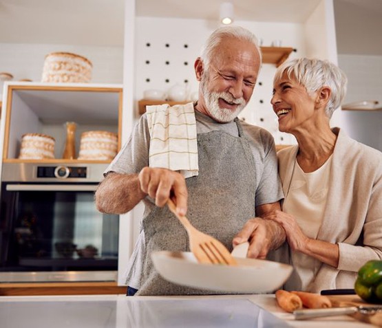 Older couple preparing a meal together