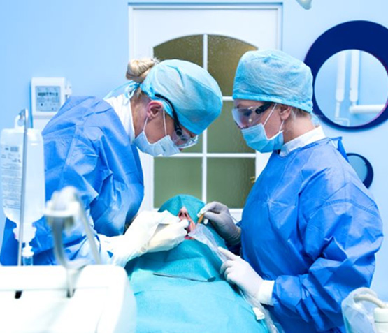Dental team carefully performing surgery on patient