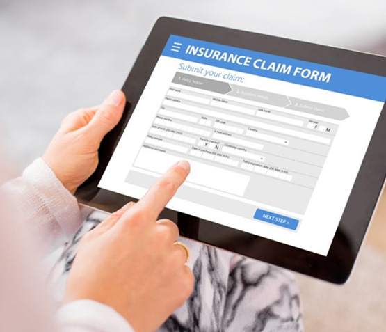 Person filling out insurance form on tablet