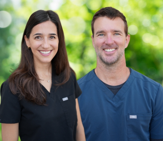Three dentists at Carolina Complete Dental smiling outdoors