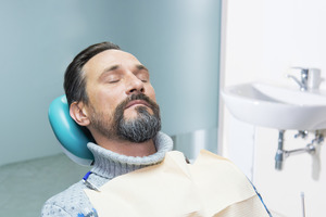 Man with beard relaxing in dental chair